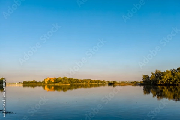 Obraz A confluence of Narew (left) and Vistula (right) rivers with lush green banks.
