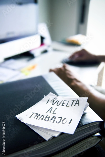 Fototapeta man at office and text back to work in spanish