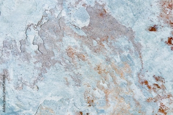 Fototapeta Natural stone texture with earthy tones of gray and rusty orange, showcasing rough surface patterns and organic details, ideal for backgrounds or design elements.