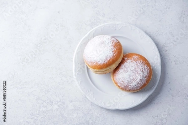Fototapeta Berliner donuts with powdered sugar topping in a plate