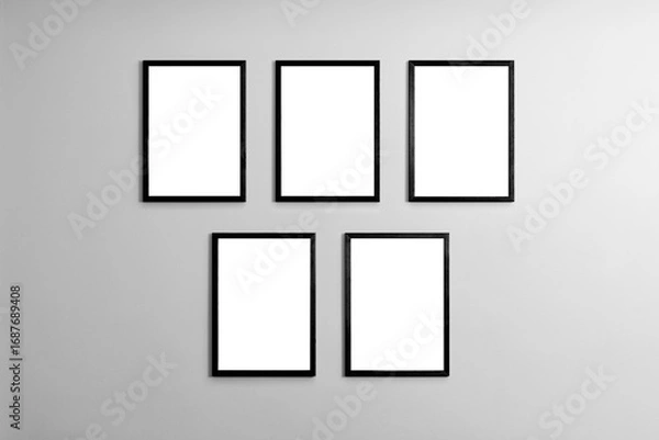 Fototapeta Modern minimal interior with one two three  four  five blank black  wooden photo frames light gray wall, mockup template for artwork, posters or prints, Scandinavian design, home decor, gallery wall