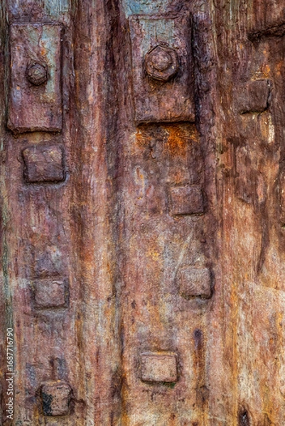 Fototapeta Old Rusty cast iron plate with bolts  for use as a background or texture