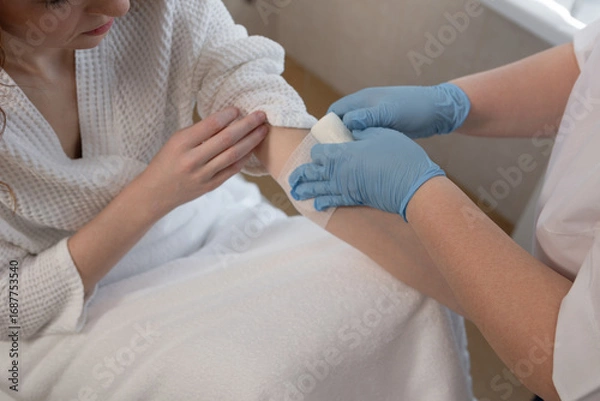 Fototapeta Close-up of venipuncture procedure with needle in arm for diagnostic blood test in hospital