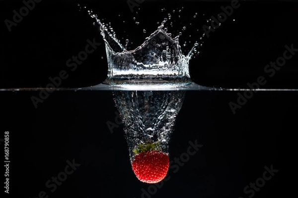 Obraz A strawberry splashing into water