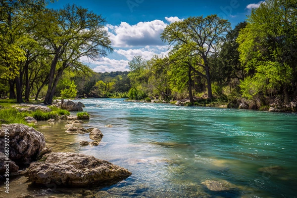 Fototapeta The Guadalupe River in the spring, blue water, green trees, rocks on the shore, clear sky, professional photography in the style