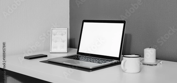 Fototapeta Laptop opened with white screen a cup of coffee or tea with a mobile phone placed on a white table in a living room for Work from home e-learning digital classes connectivity for Business ads 