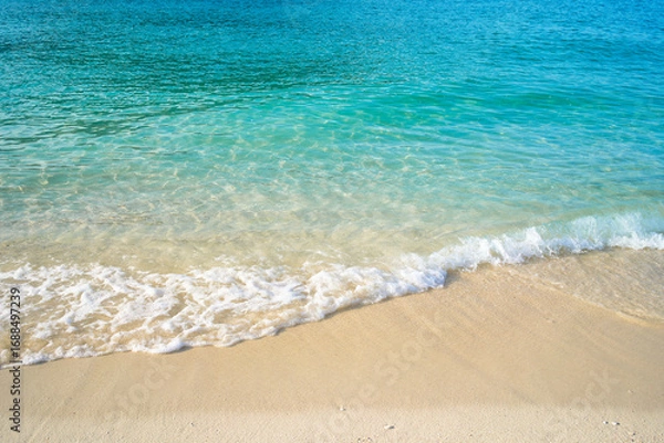 Fototapeta Clear ocean water and sand beach for vaction time.