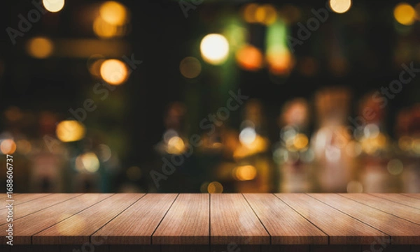 Fototapeta Empty wooden table top with lights bokeh on blur restaurant background.	