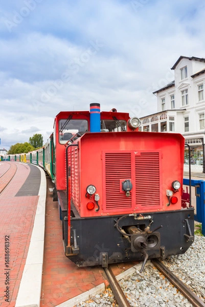 Fototapeta Red locomotive on the platform in the center of Borkum