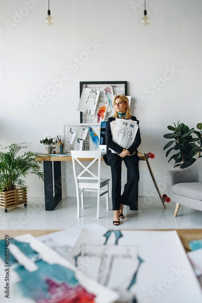 Fototapeta young fashion designer with sketches