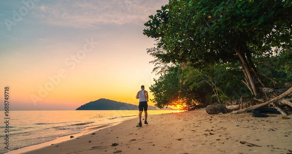 Fototapeta The beach provides the great environment for a challenging and enjoyable workout. Run on sand increase metabolic and heart rate as body has to work harder to cool itself down, burn more calories.