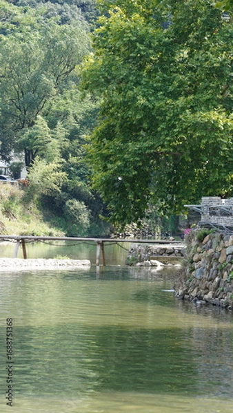 Fototapeta The classical wooden bridge view located in the countryside of the China
