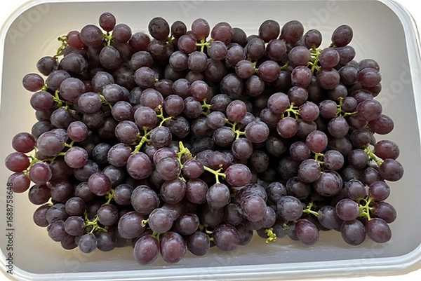 Fototapeta A bunch of fresh red grapes with some grapes on a plate and in a bowl.