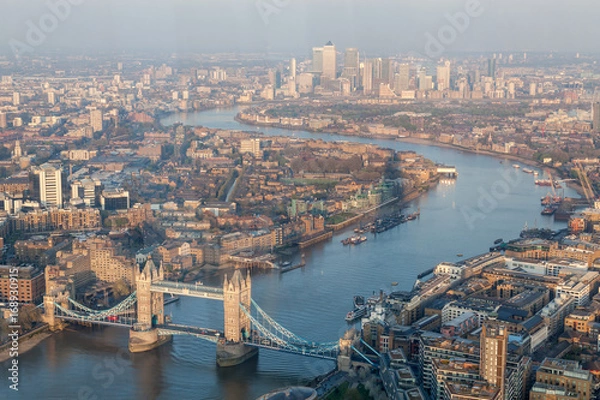 Fototapeta a view of Thames river and London at sunset with red sky and air pollution with Tower bridge