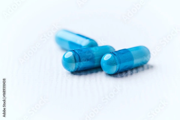 Fototapeta Amino acids capsules on bright background. Soft focus. Close up. Copy space.	