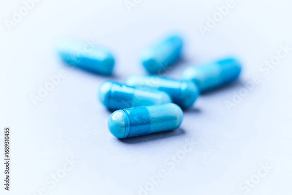 Fototapeta Amino acids capsules on bright background. Soft focus. Close up. Copy space.	