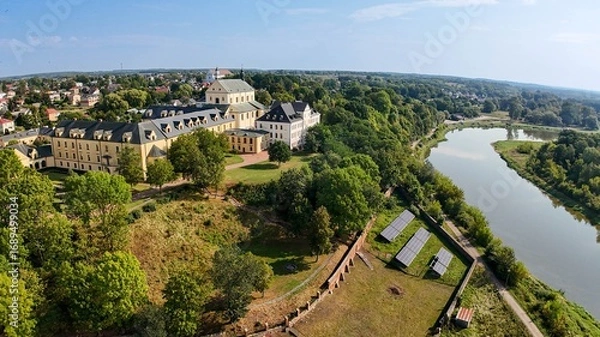 Fototapeta Aerial view of scenic Holy trinity Cathedral on the hill over the Bug River in Drohiczyn