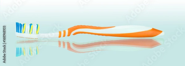 Obraz Оранжево белая зубная щетка на зеркальном фоне