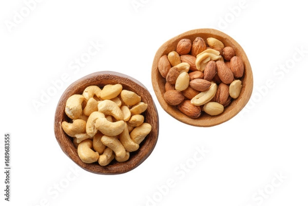 Obraz Two wooden bowls of nuts, one with cashews, the other with almonds and cashews