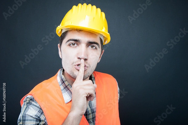 Obraz Constructor wearing equipment showing silence gesture