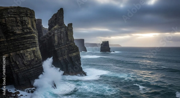 Obraz Dramatic Coastal Cliffs and Ocean Waves Crashing Against Rugged Rocks at Sunset