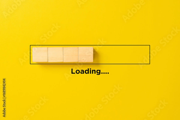 Fototapeta Loading bar concept made of wooden blocks inside a progress bar on yellow background, symbolizing process, waiting time, development, and technology progress.