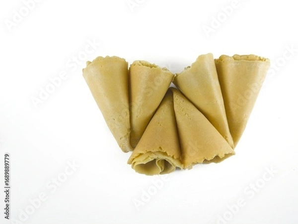 Fototapeta Semprong cake, sapit, sepit, Dutch cake, gapit, kassipi, kapit, Asian egg roll. A waffle or pastry snack originating from Indonesia. Semprong cake isolated on a white background.