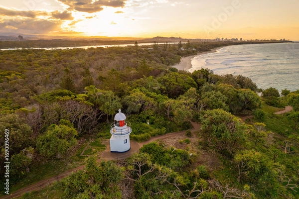 Fototapeta Sunset aerial views of Fingal Head Lighthouse with the causeway rock formations below in Fingal Head, New South Wales, Australia