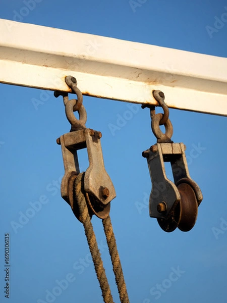 Fototapeta Old vintage Block and pulley tackle on metal frame harbour quayside