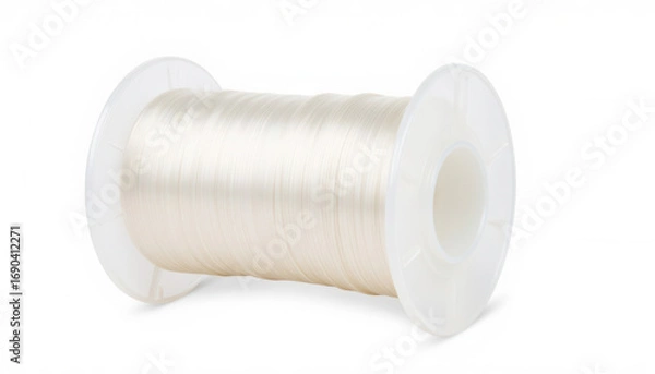 Obraz Transparent sewing thread on white spool for crafting and repairs  