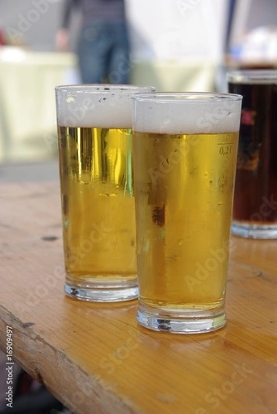 Fototapeta Two beers on a wooden bench in a biergarten