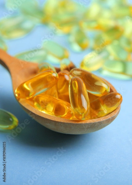 Fototapeta Omega 3 capsules on a colored background close-up with place for text.. Vertical photo format 