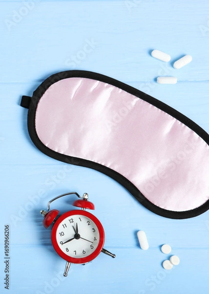 Fototapeta Composition on the theme of insomnia on a colored background. Vertical photo format 
