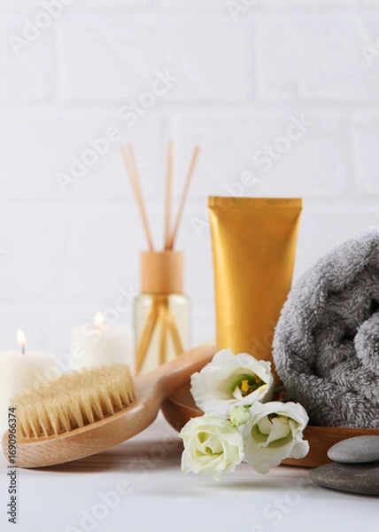 Fototapeta Beautiful spa composition of towels and spa accessories. Vertical photo format 