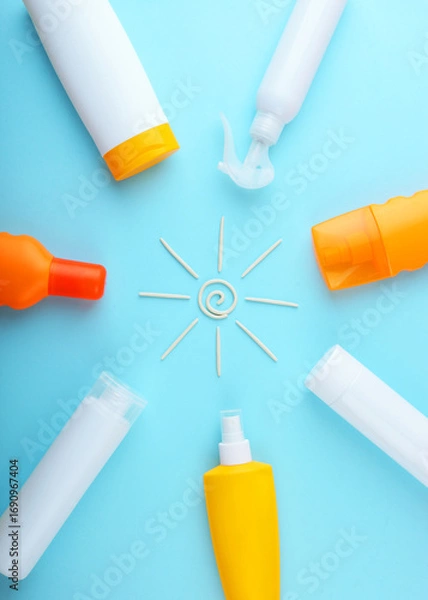 Fototapeta Sunscreens on a colored background top view.. Vertical photo format