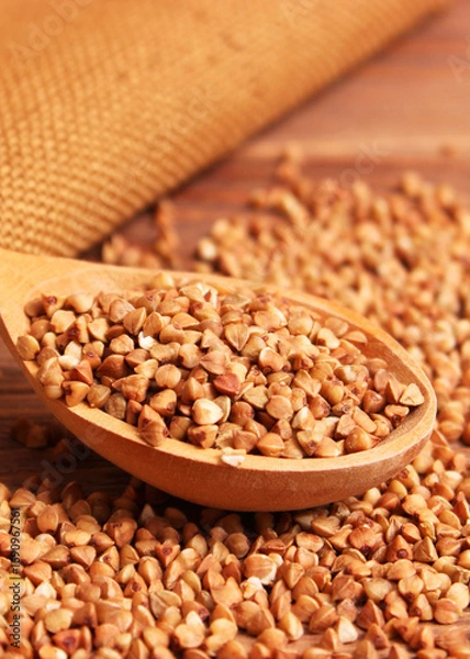 Fototapeta raw buckwheat on a colored background close-up.. Vertical photo format