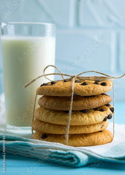 Fototapeta Delicious cookies with chocolate chips on a colored background. Vertical photo format
