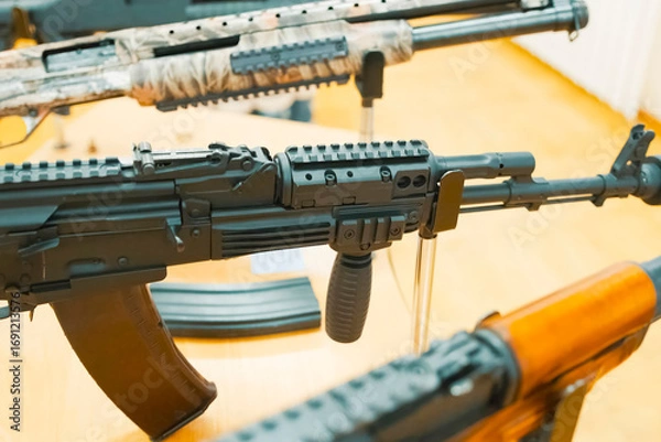 Fototapeta Kalashnikov assault rifle on display stand at an exhibition.