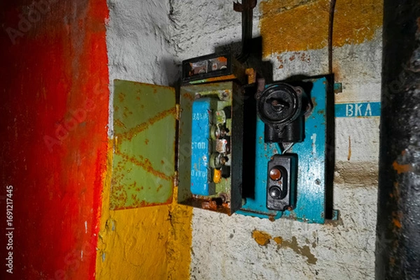 Fototapeta start switch is a stop on the wall of an abandoned bunker. non-working electrical equipment