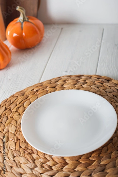 Fototapeta Empty White Plate on Autumn Table Setting with Pumpkins