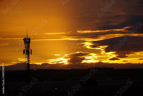 Obraz Telecommunication tower at sunset with dramatic sky