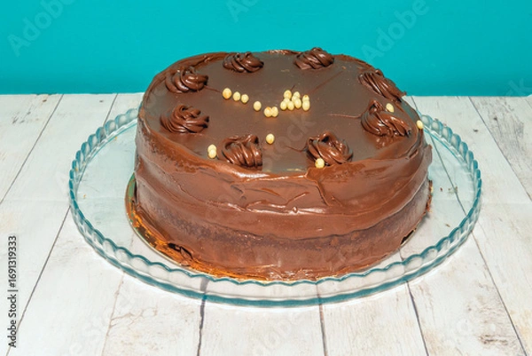 Fototapeta Chocolate and strawberry cake with layers of light mascarpone cream and white chocolate shavings