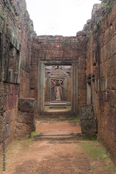 Fototapeta Corridor of Stone Walls to a Wood Door in Siem Reap Angkor Wat Temple Cambodia Asia