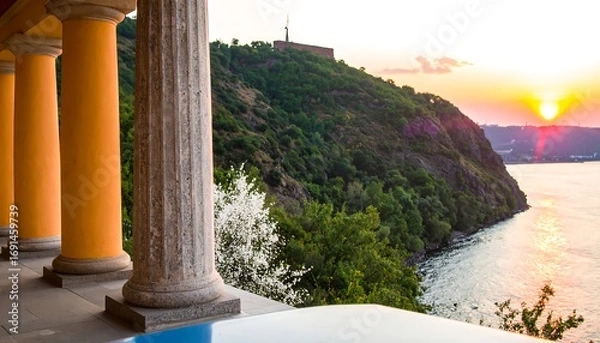 Fototapeta Panoramic view of a colonnade overlooking a sunset over water