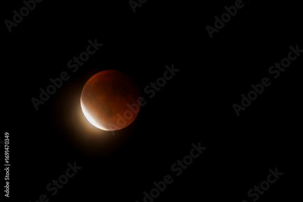Fototapeta Lunar Eclipse on Sunday 7 September, 2025. Shot with an 800mm lens from Mtarfa in Malta.  Here the Moon has just started to exit the Earth's shadow