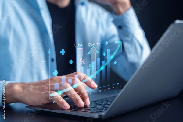 Fototapeta Businessman analyzing cost and quality management graph on laptop business growth, performance improvement, financial strategy, and decision making.