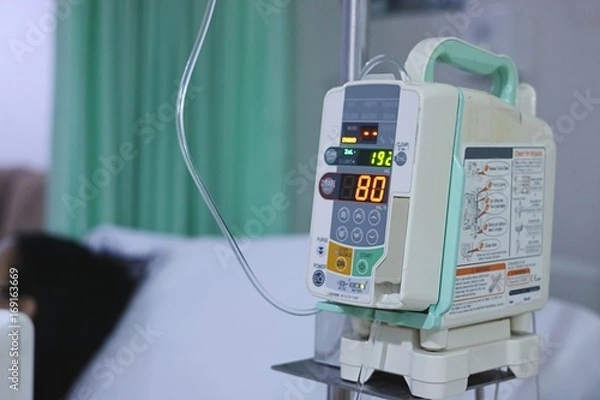 Obraz Infusion pump intravenous IV drip in the hospital with copy space background.
