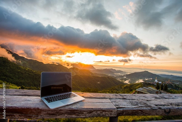 Fototapeta Freelancer office in mountain cafe. Online webinar everywhere via 4ginternet with mountain and sunrise background.