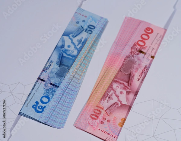 Fototapeta Man counting cash in indoor setting wearing colorful patterned shirt and accessories
