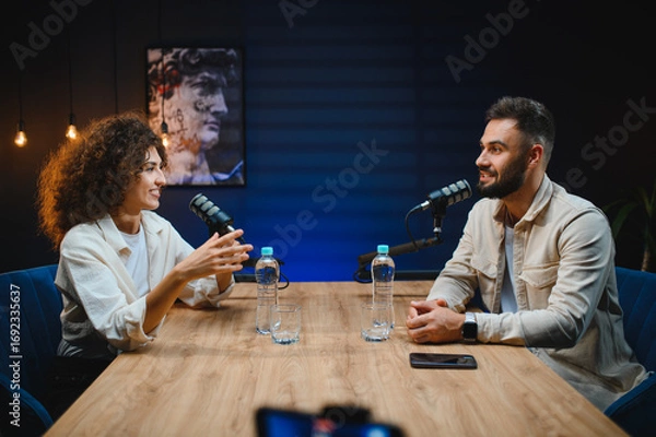 Fototapeta Podcasters recording audio content in modern studio